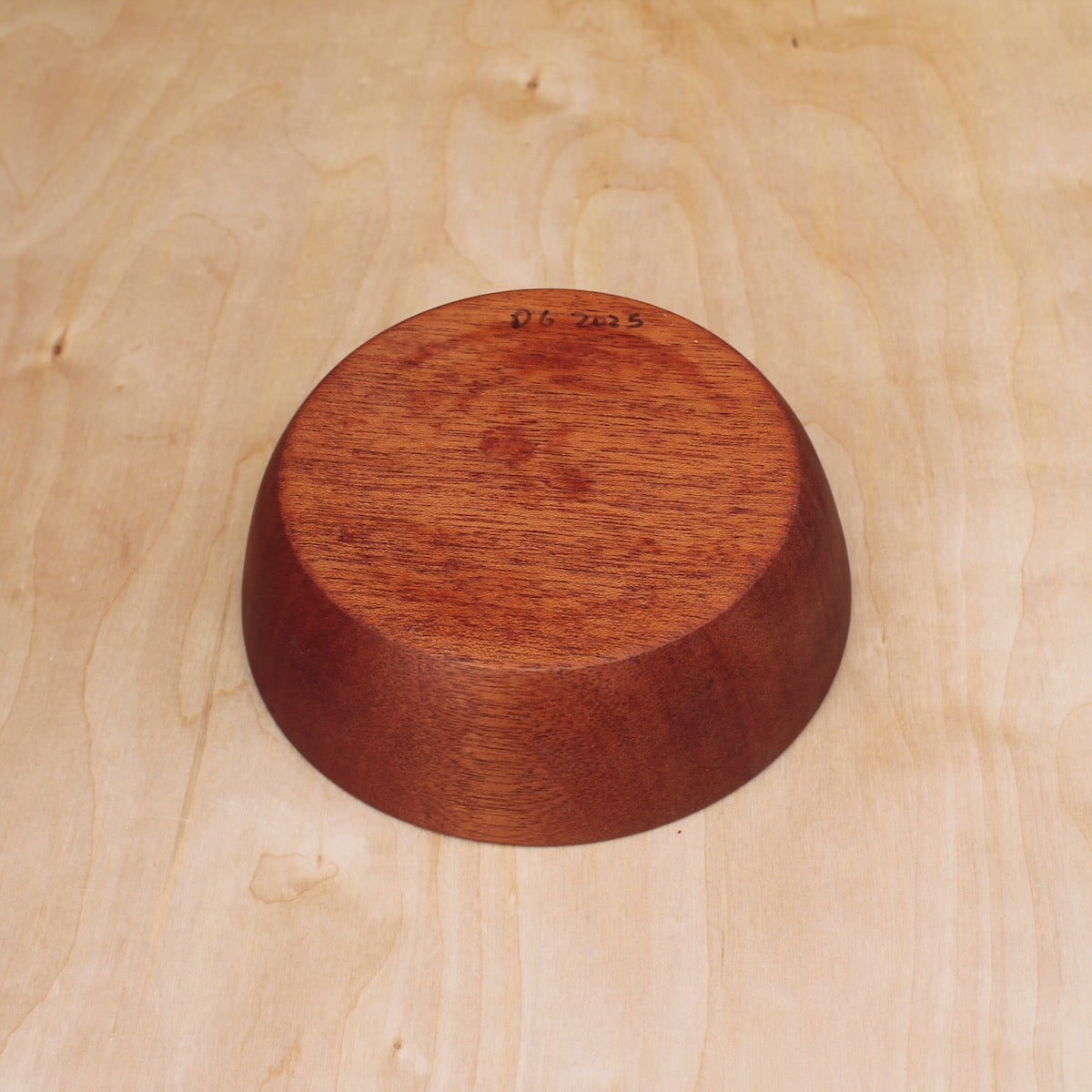 bottom of a red wooden bowl