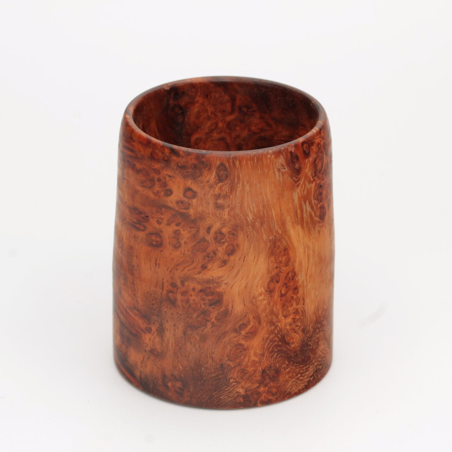 hand made wooden glass with rich reddish‑brown tones accented by lighter golden swirls