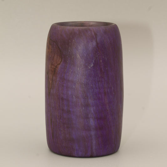 Amethyst colored wood shot glass against white background