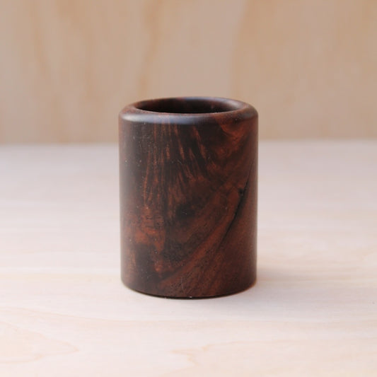 Wooden cup with a marbled pattern on a light background