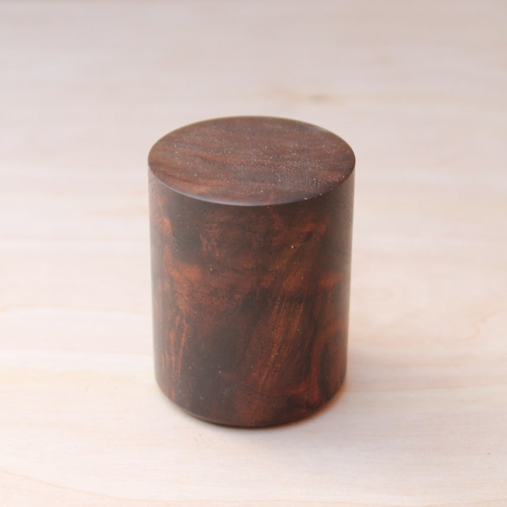 bottom of a chocolate brown, marbled wooden shot glass