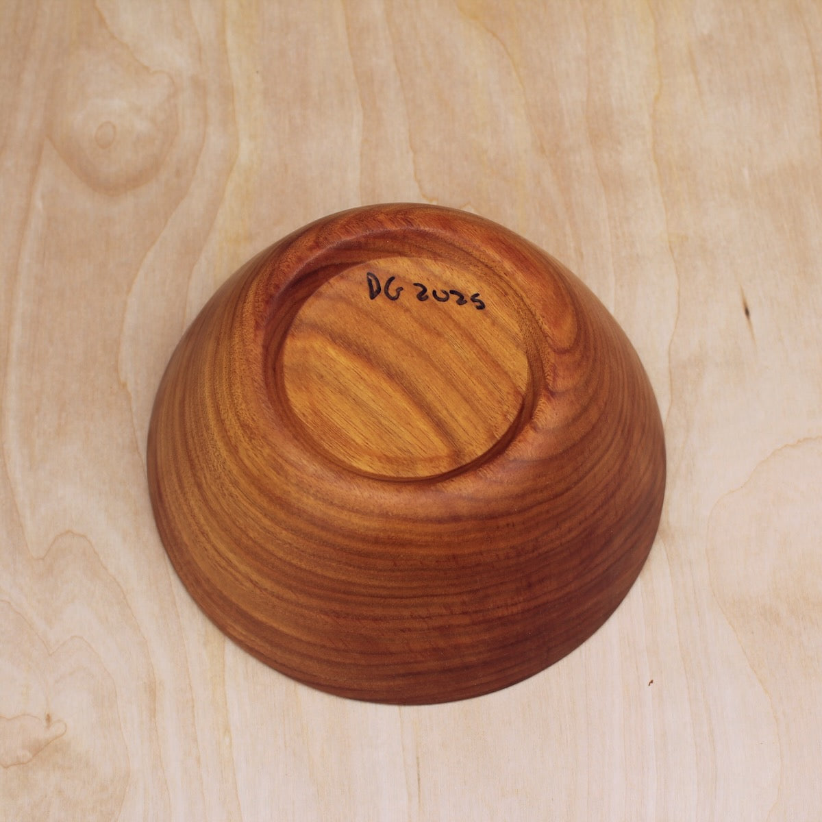 bottom of a hand made wooden salad bowl made with canary wood