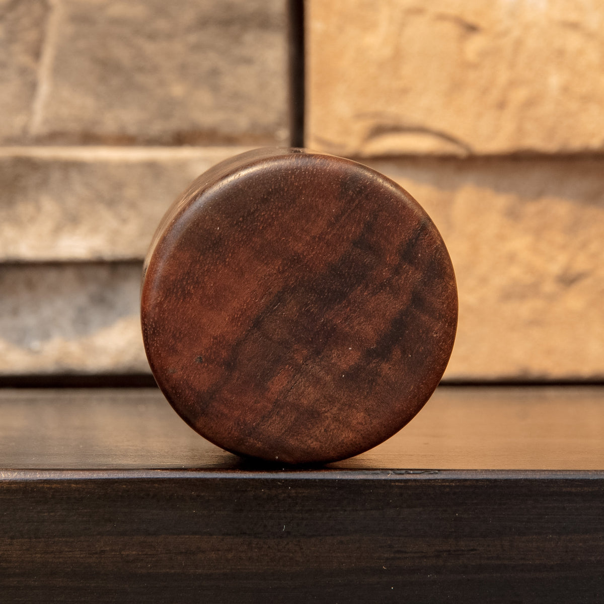 Bottom of Claro Unbound shot glass showing dark reddish-brown Claro Walnut end grain