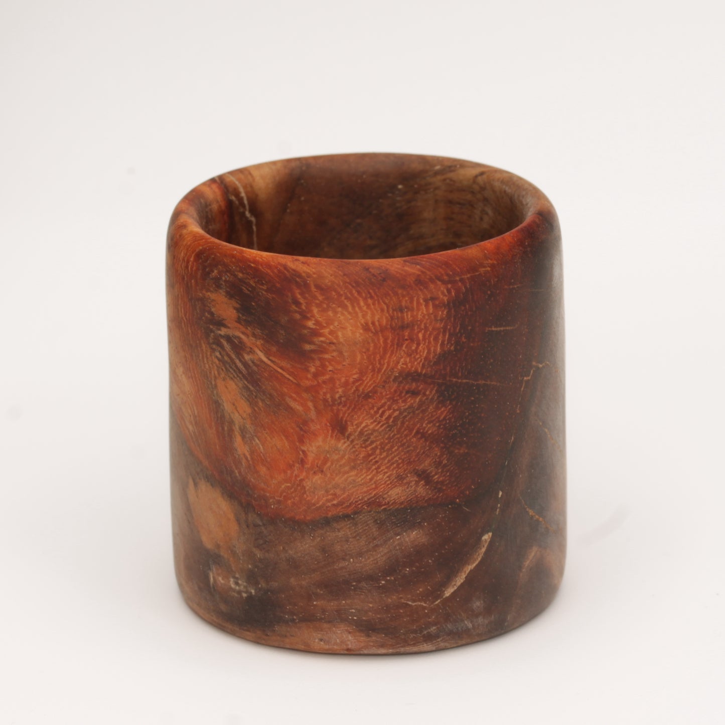 Amboyna burl shot glass against white background