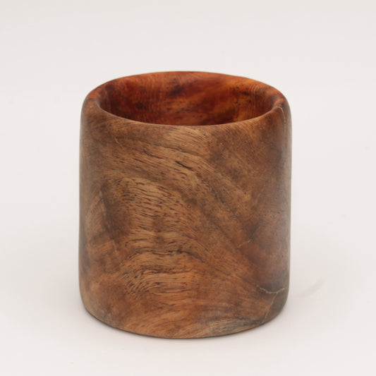 Amboyna burl shot glass against white background