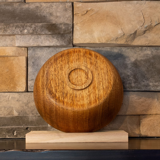 Underside of the Mango serving bowl showing its rounded profile, recessed foot, and varied grain