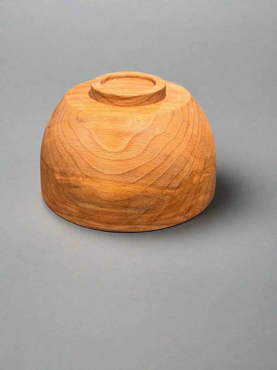 Wooden bowl on a textured gray surface