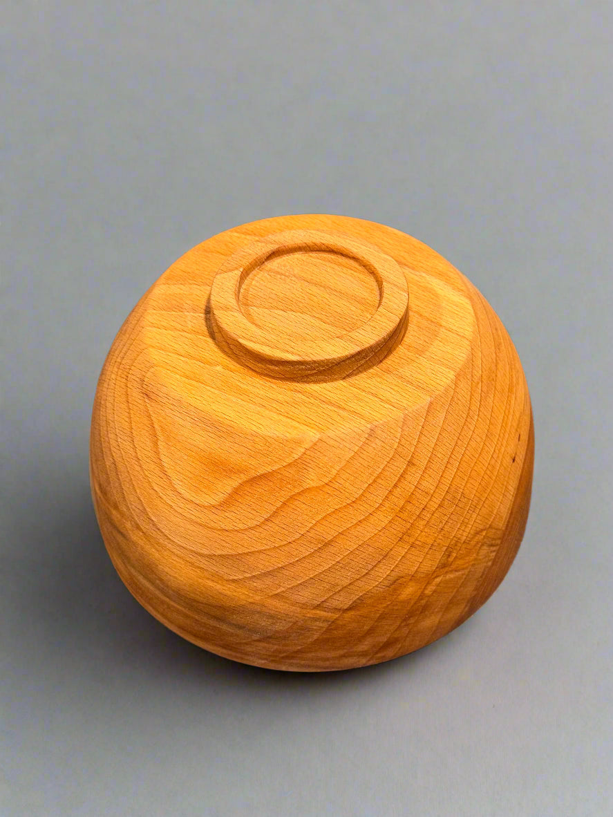Wooden bowl on a gray surface