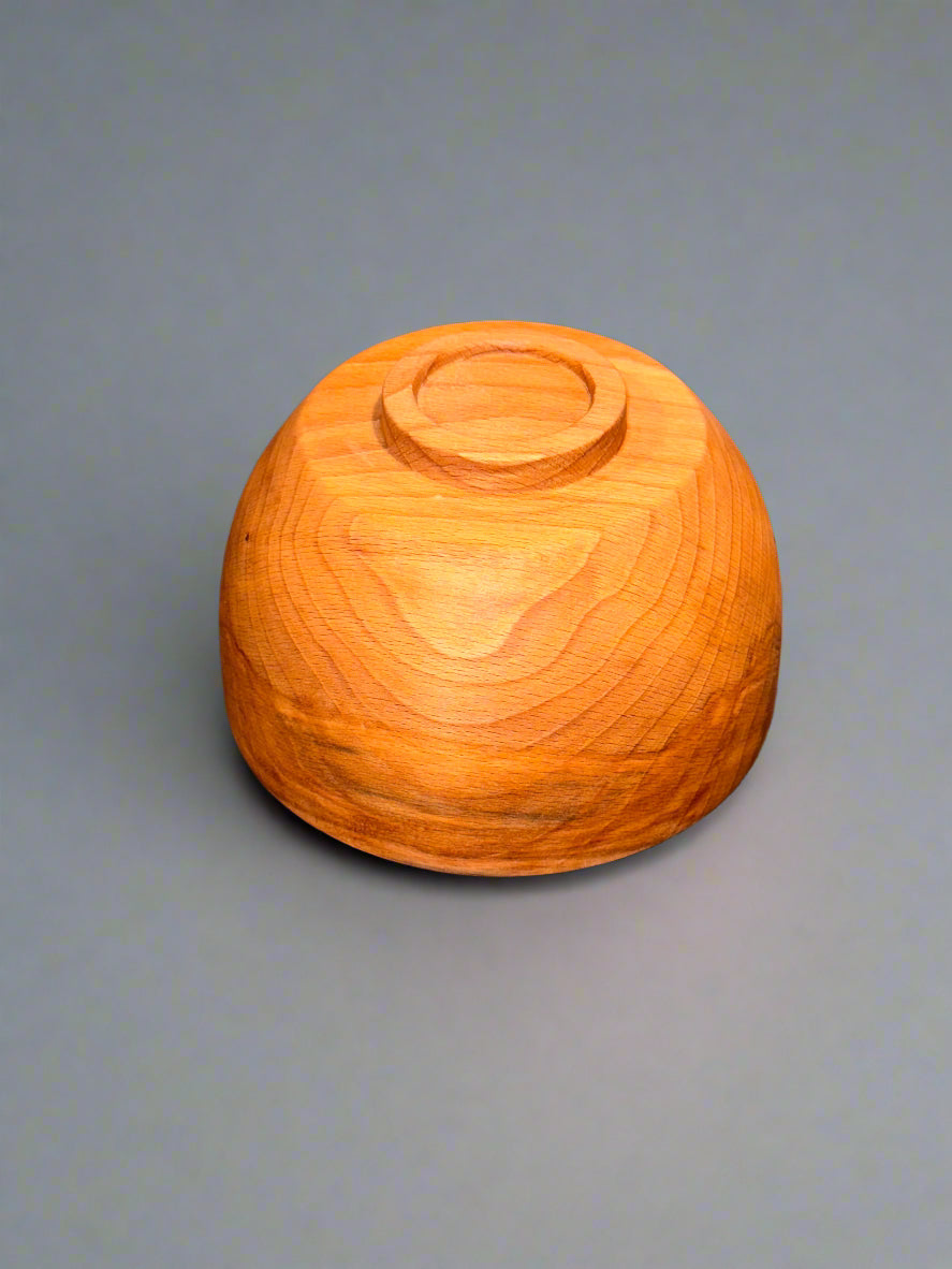Wooden sphere on a textured gray surface