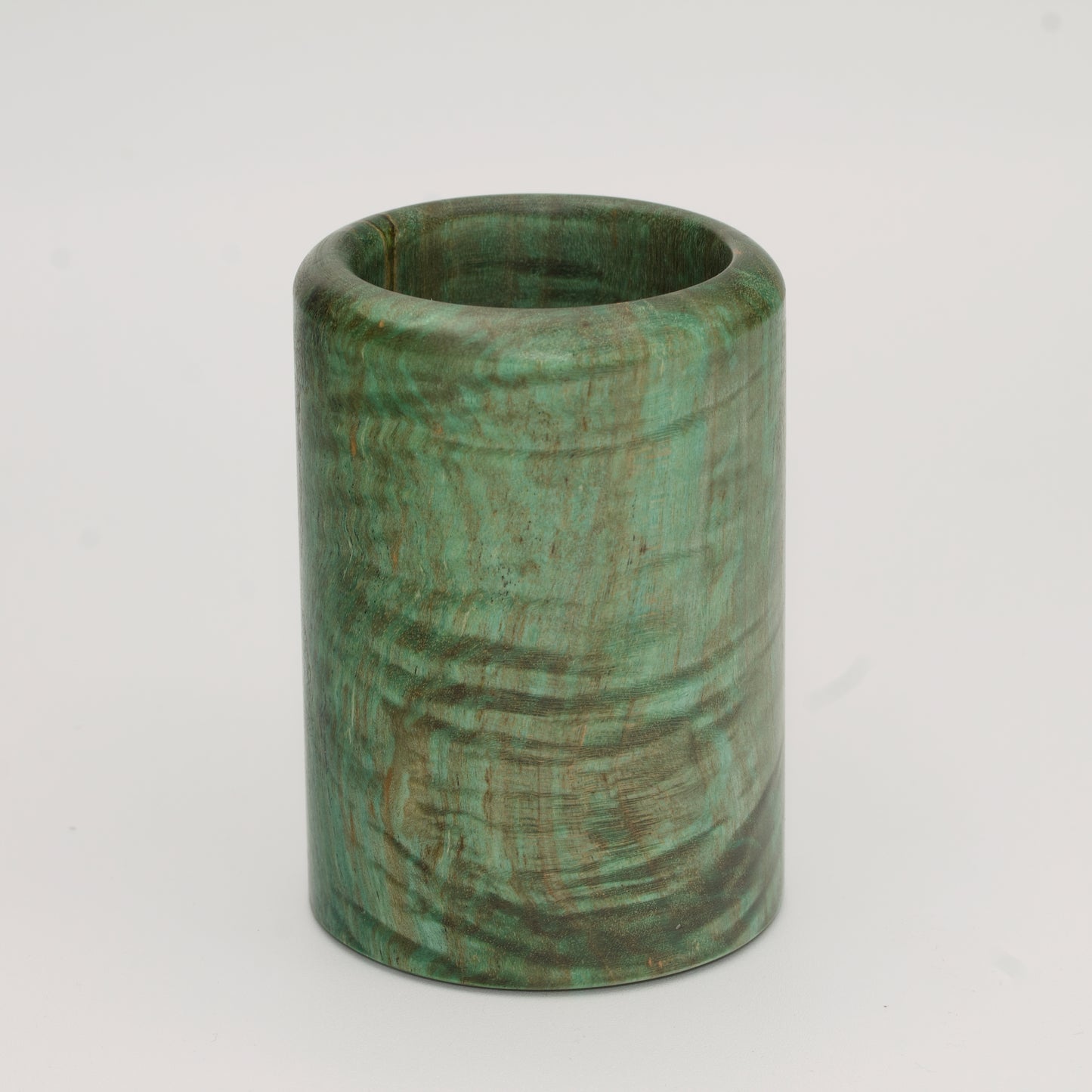 Green dyed curly spalted maple burl shot glass against white background