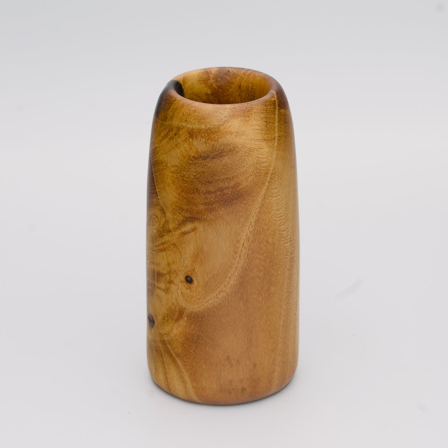 Stunning tall mulberry wood shot glass against white background