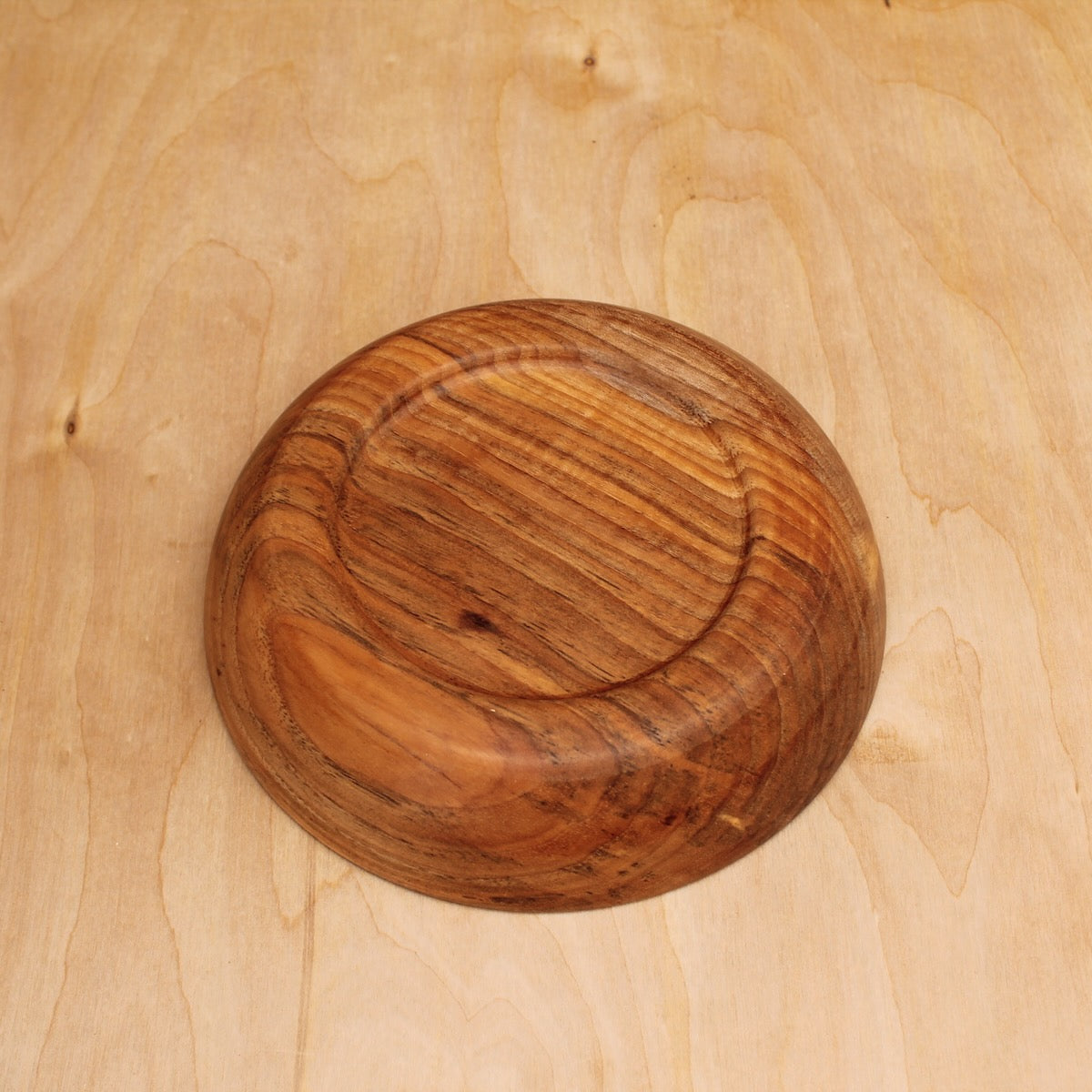 bottom of a wooden pasta bowl