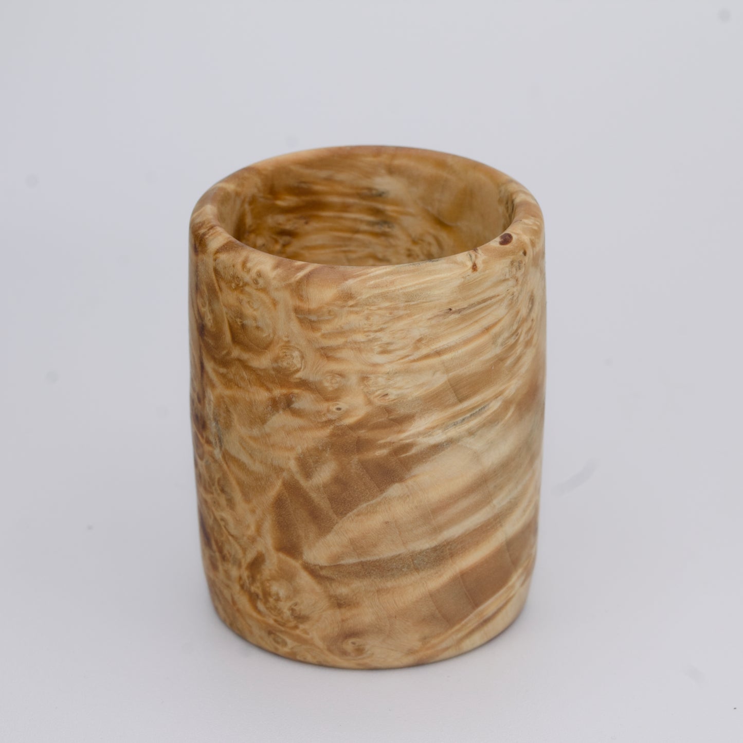 Box Elder burl wood shot glass against white background