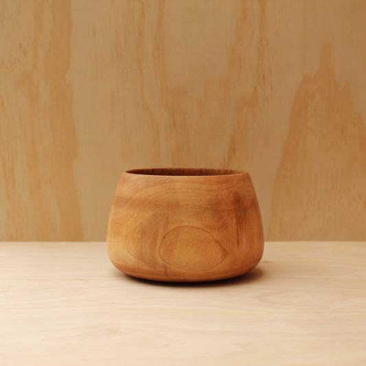 Wooden pot on a wooden surface with a wooden wall background