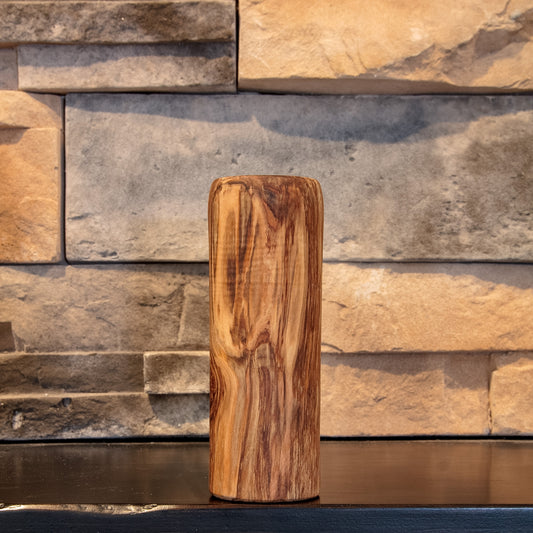 The Eddy shot glass showing broad light-and-dark grain sweeping down the tall exterior
