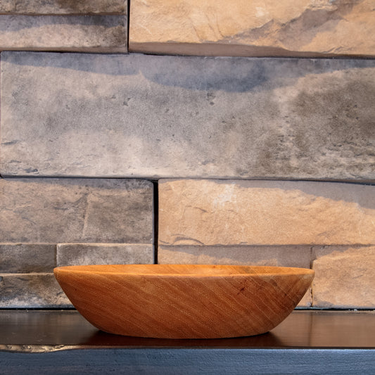 The Patient Grain Illinois pecan candy bowl showing its shallow profile and diagonal golden-brown grain