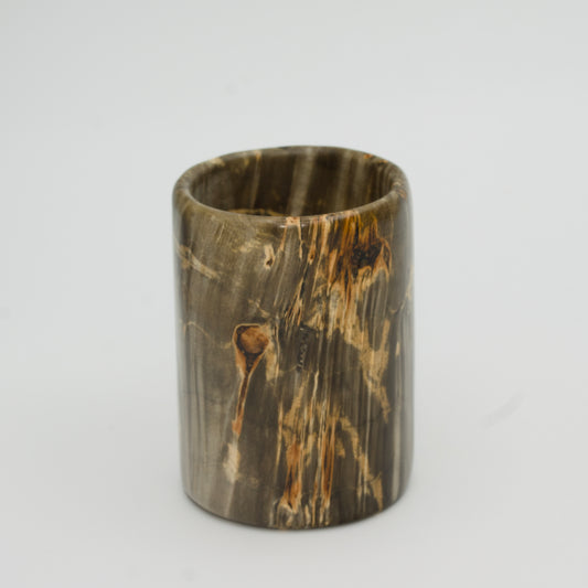 Green boxer elder burl shot glass against white background