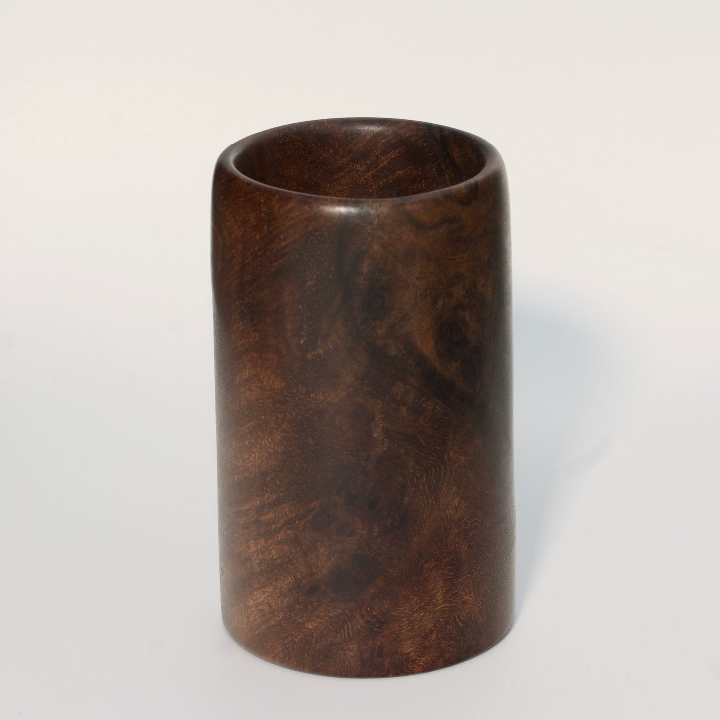 Walnut burl wood shot glass on white background