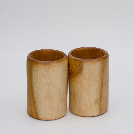 Pair of white mulberry shot glasses with orange glow