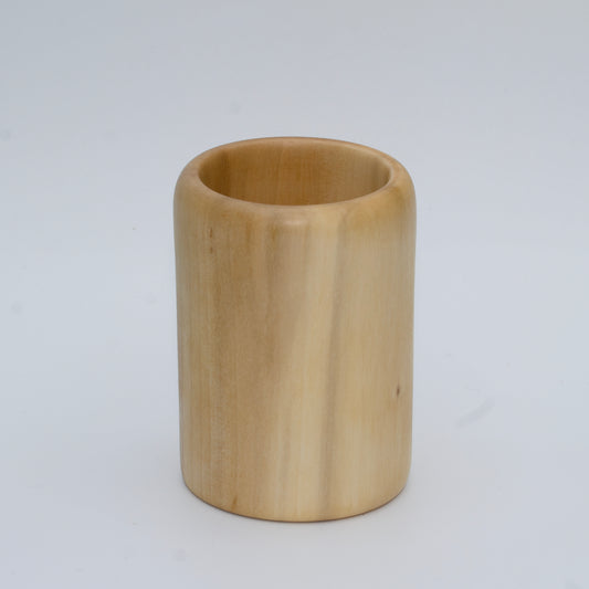 Sweetgum wood shot glass against white background