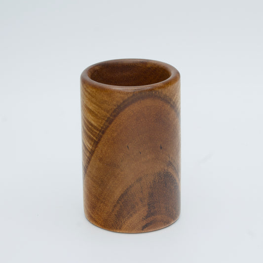Acacia wood shot glass against white background