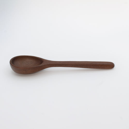 Wooden spoon on a beige background