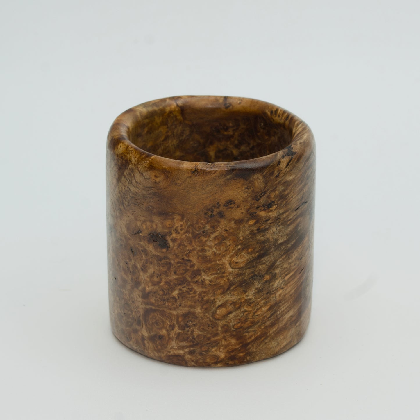 Amboyna burl wood shot glass on white background