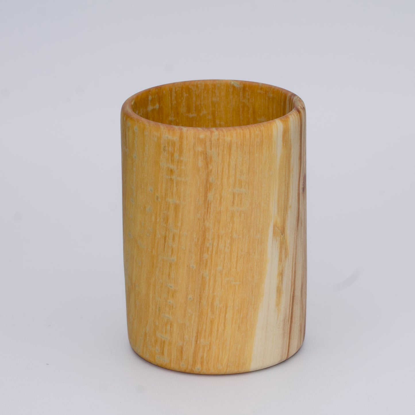 Aspen wood shot glass with gold dye against white background