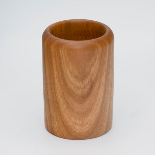 Cherry wood shot glass against white background