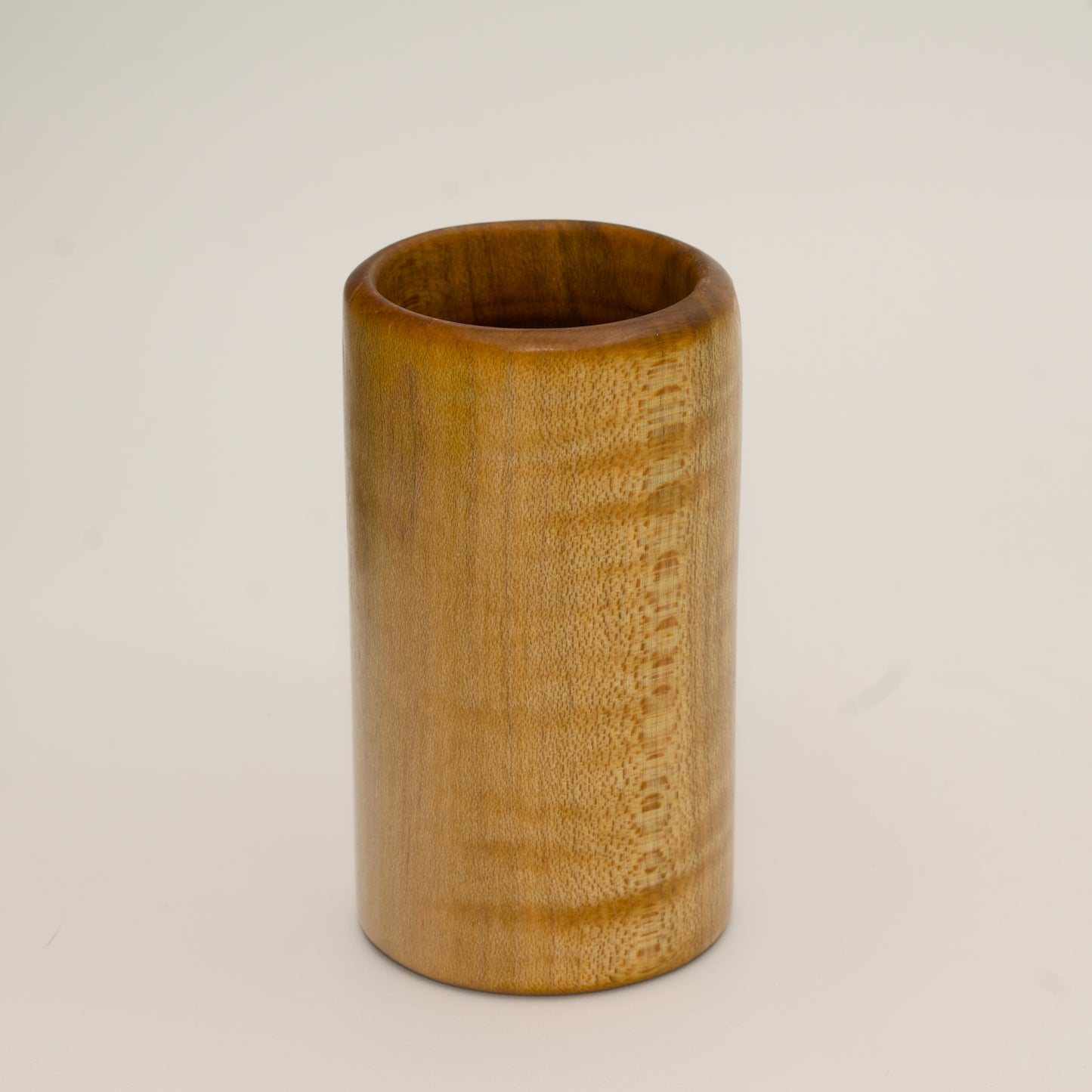 Maple burl shot glass on white background