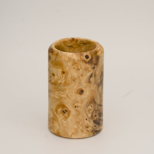 Buckeye burl wood shot glass against white background