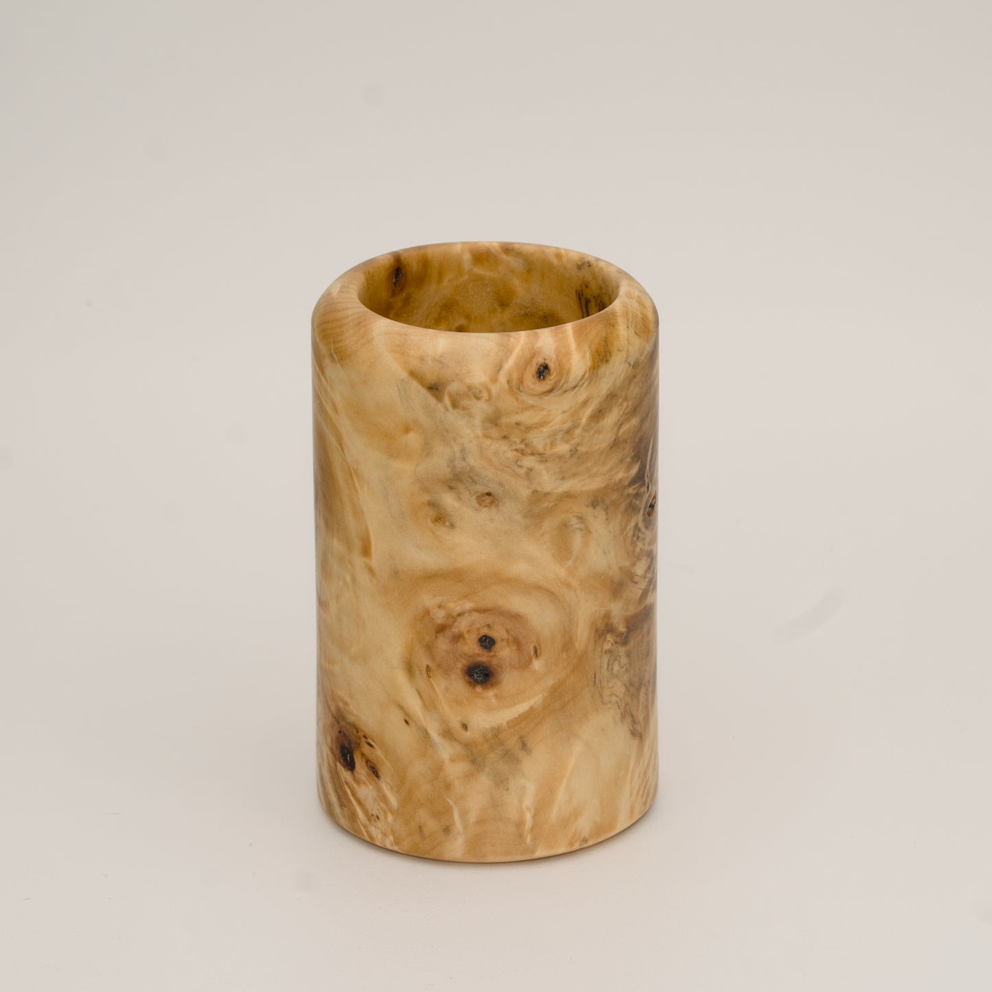 Buckeye burl wood shot glass against white background