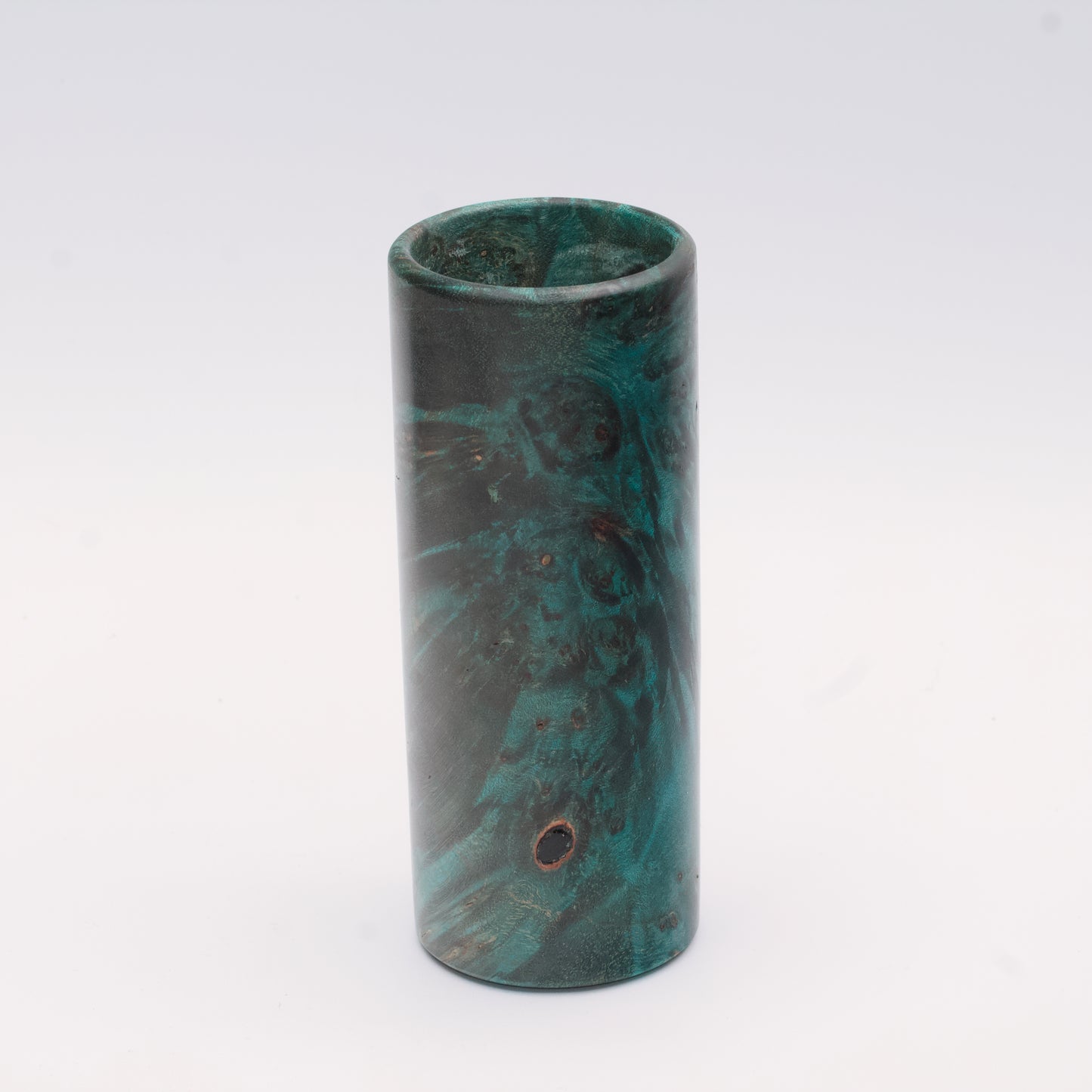 Teal Mapa Burl wood shot glass against white background