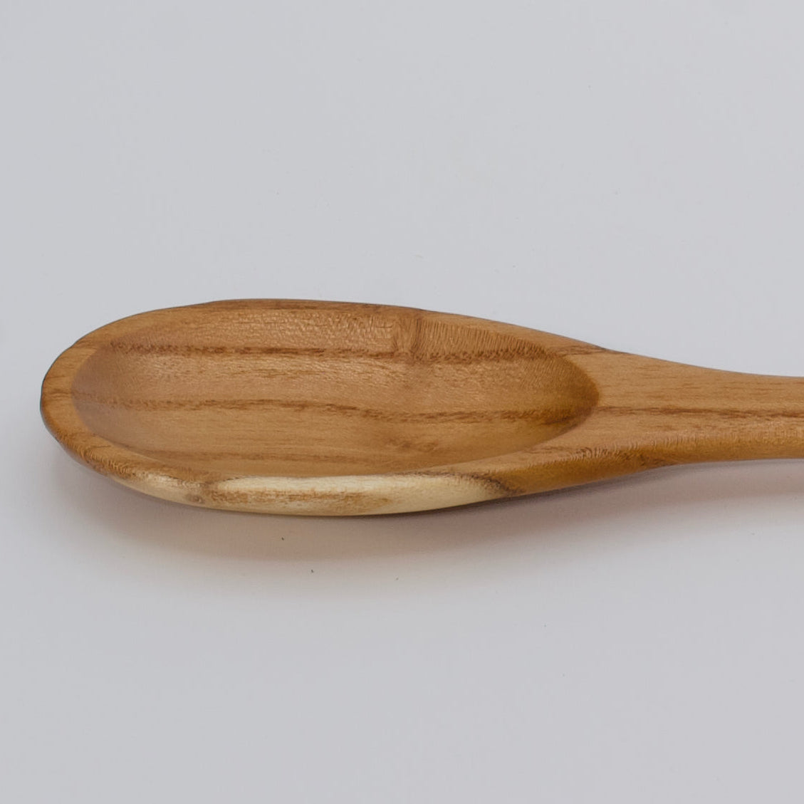 the head of a hand made wooden spatula made of white mulberry wood