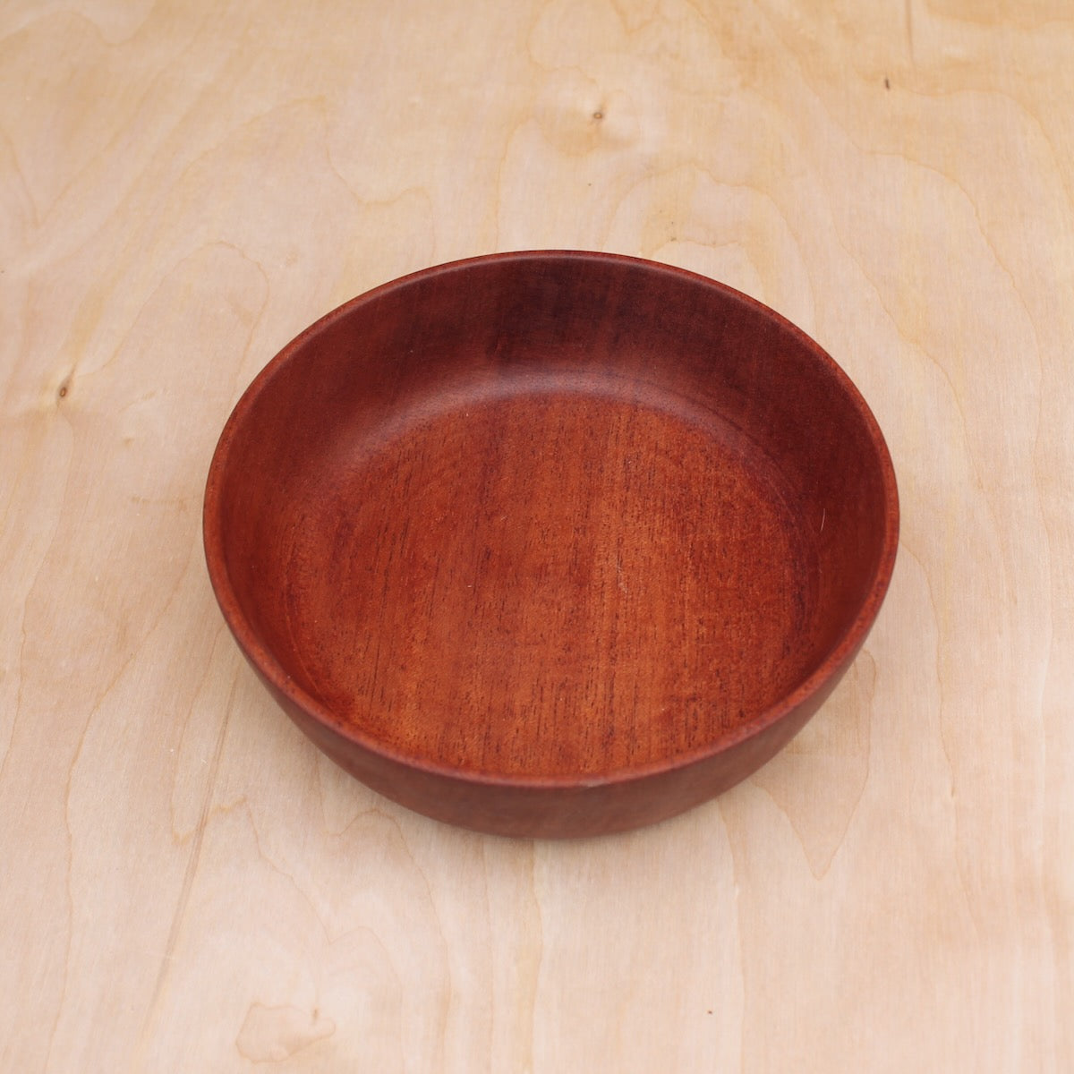 Wooden bowl on a light wooden surface
