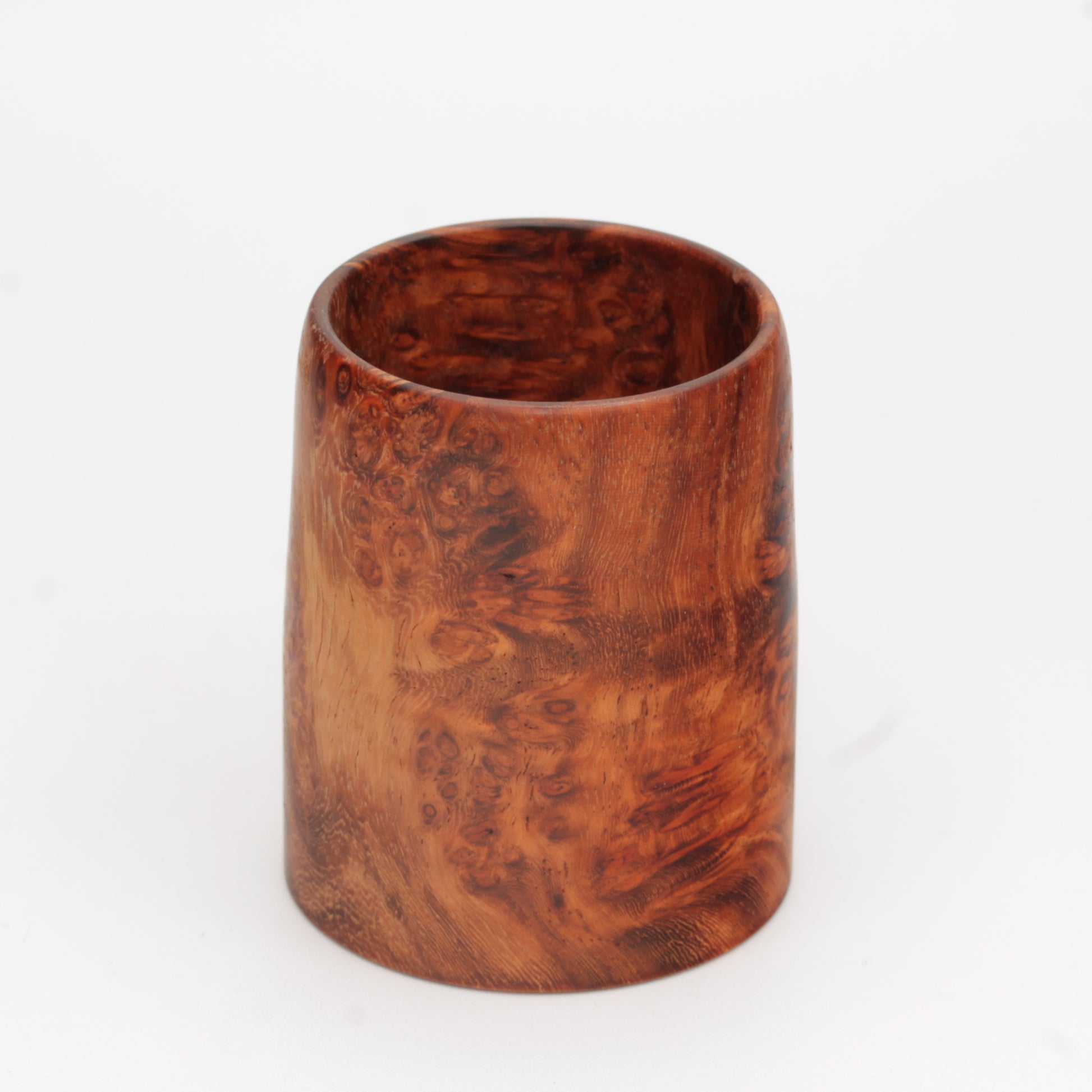 hand made wooden glass with rich reddish‑brown tones accented by lighter golden swirls