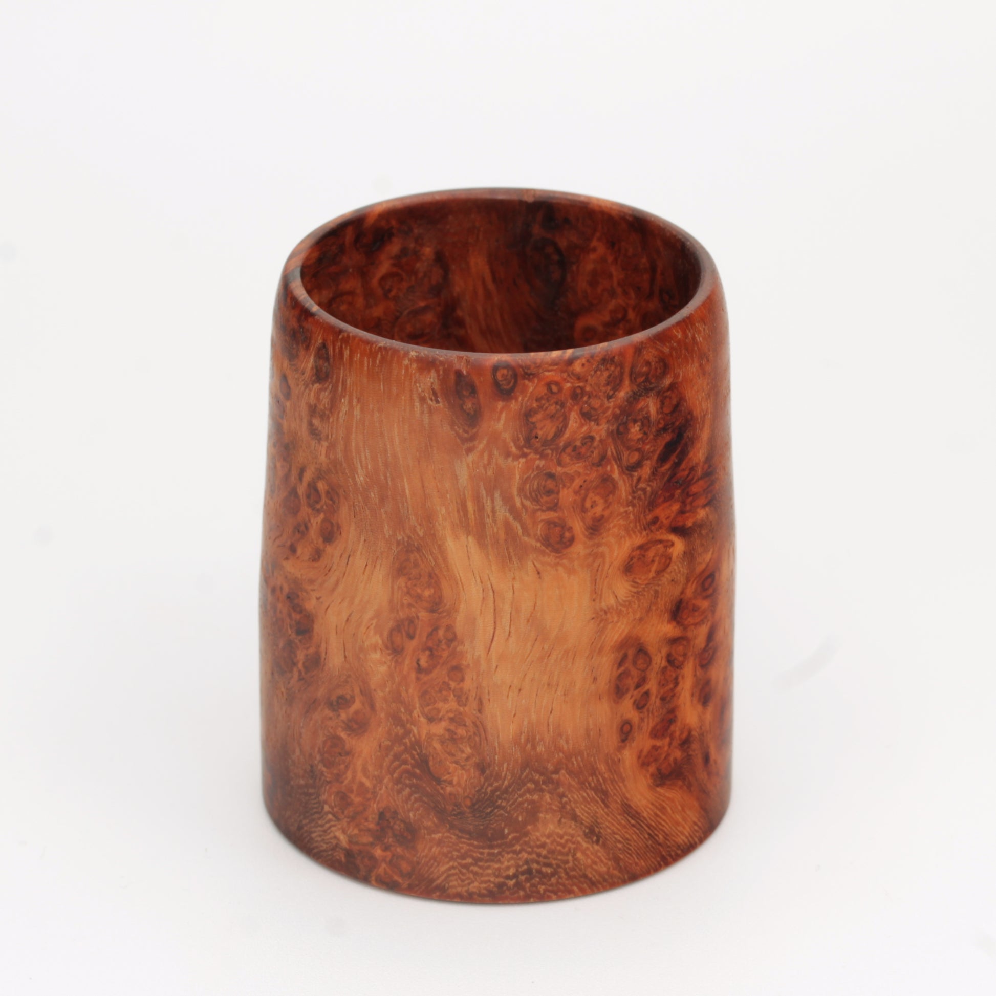 hand made wooden glass with rich reddish‑brown tones accented by lighter golden swirls