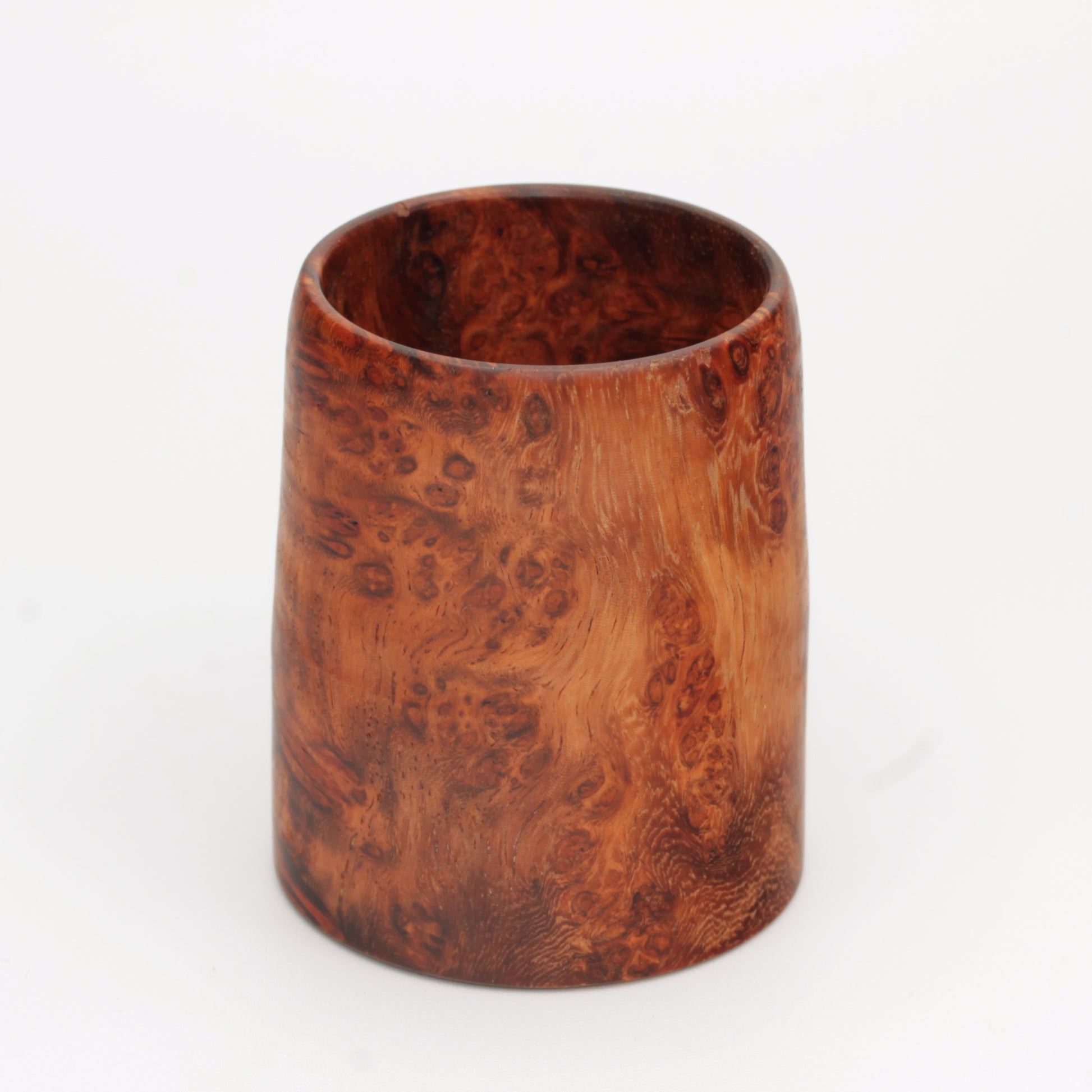 hand made wooden glass with rich reddish‑brown tones accented by lighter golden swirls