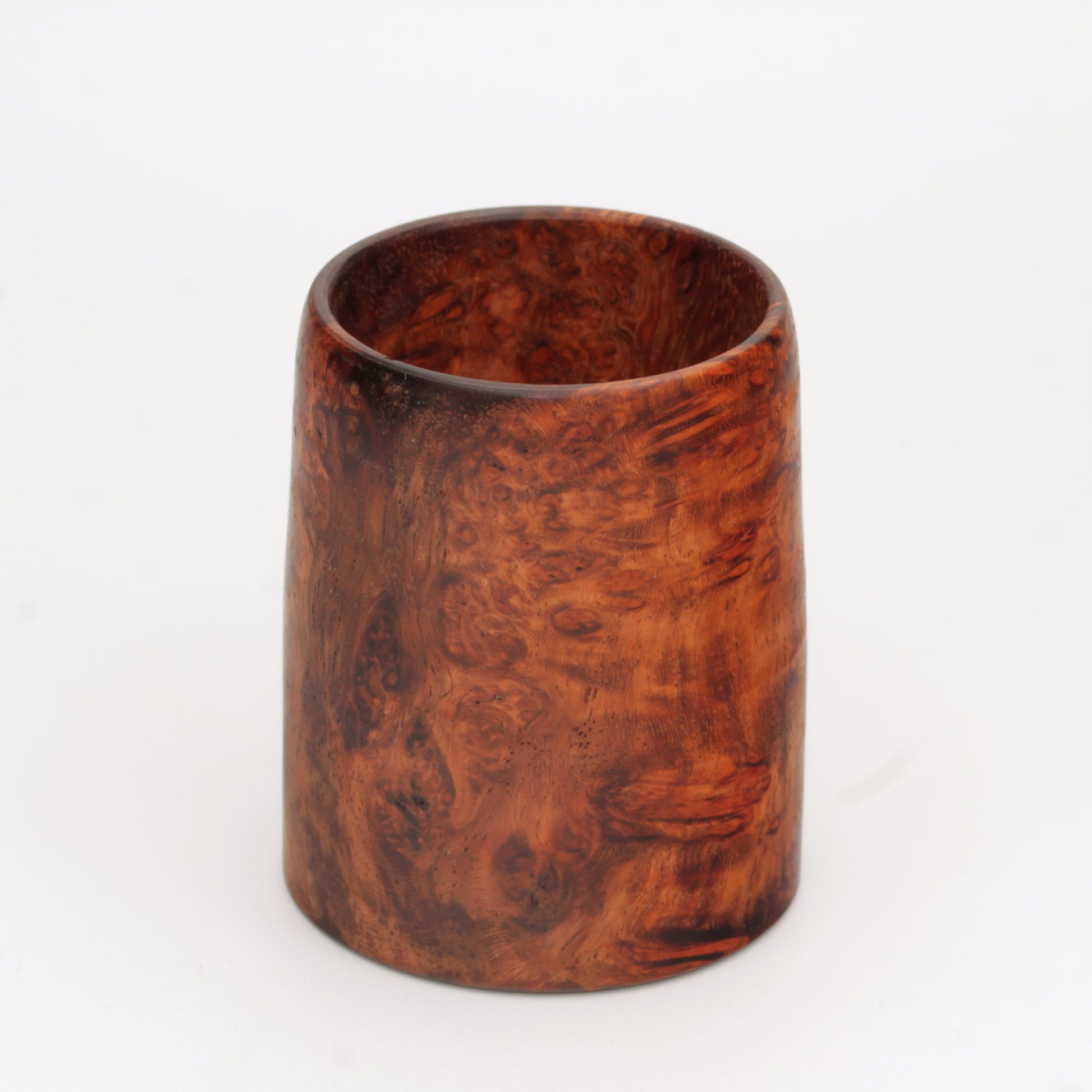 hand made wooden glass with rich reddish‑brown tones accented by lighter golden swirls