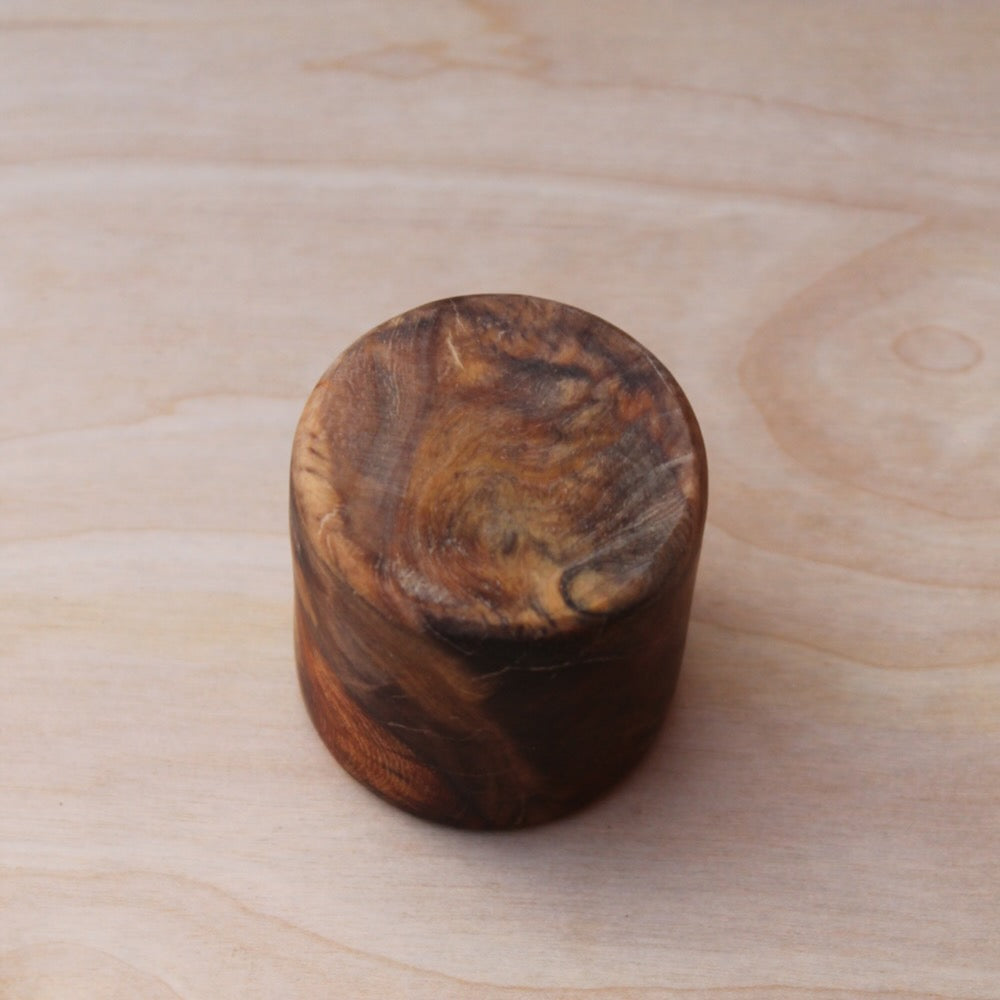 bottom of a hand crafted amboyna burl shot glass
