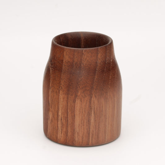 Walnut wood shot glass against white background