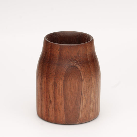 Walnut wood shot glass against white background
