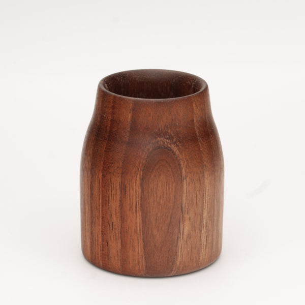 Walnut wood shot glass against white background