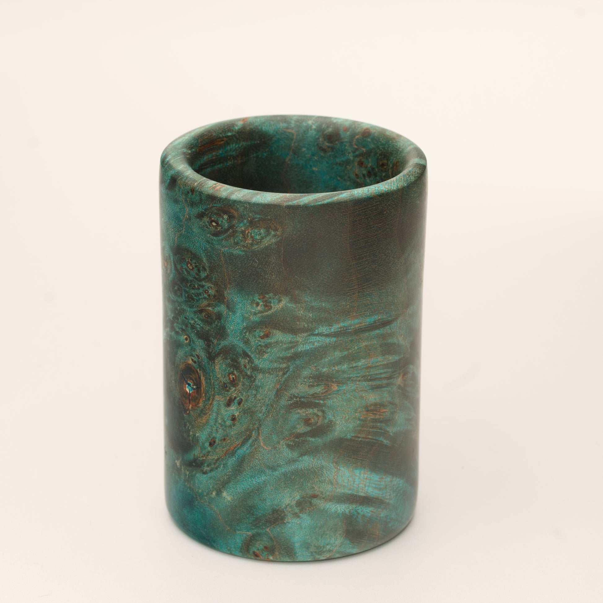 Green Dyed Mappa Burl shot glass against white background
