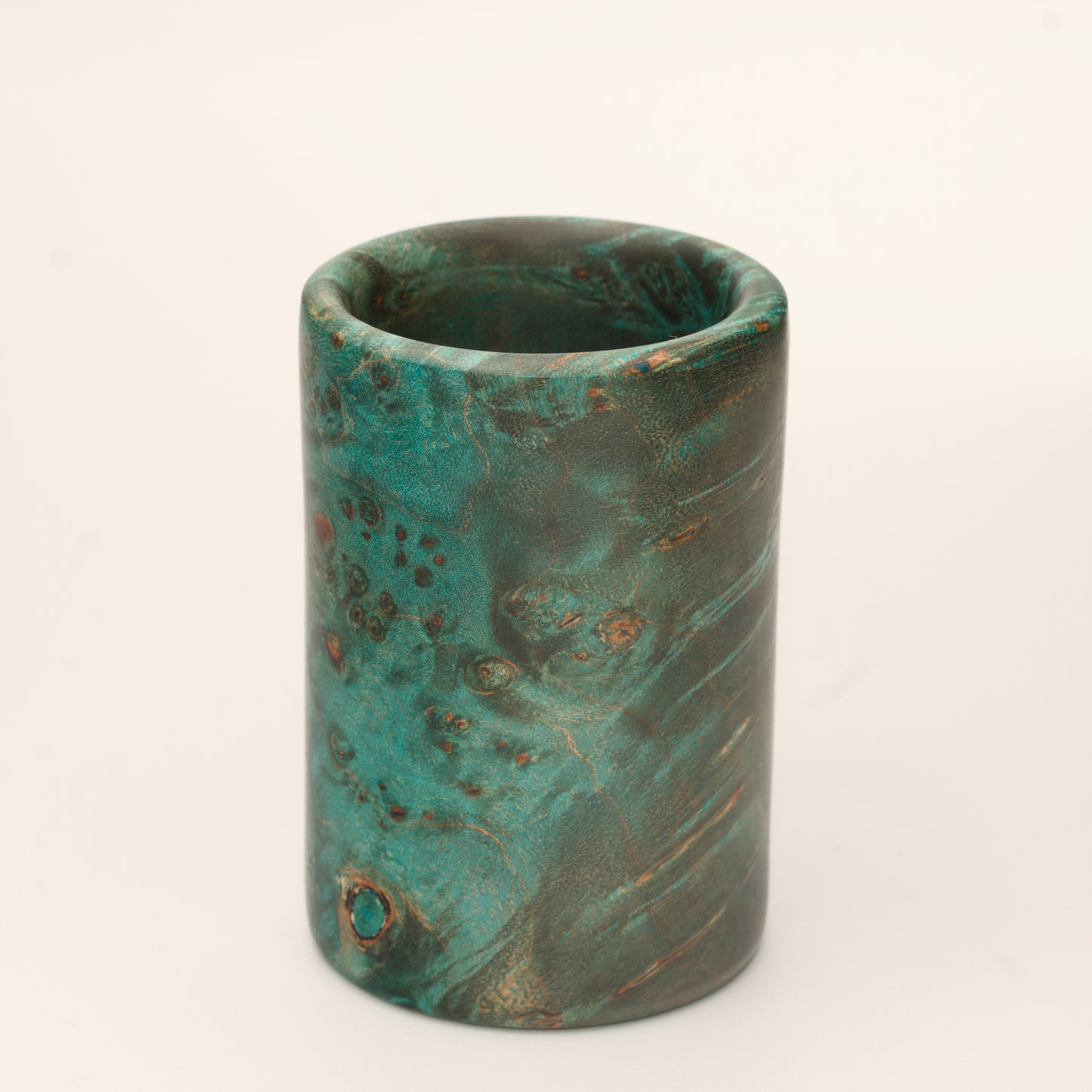 Green Dyed Mappa Burl shot glass against white background