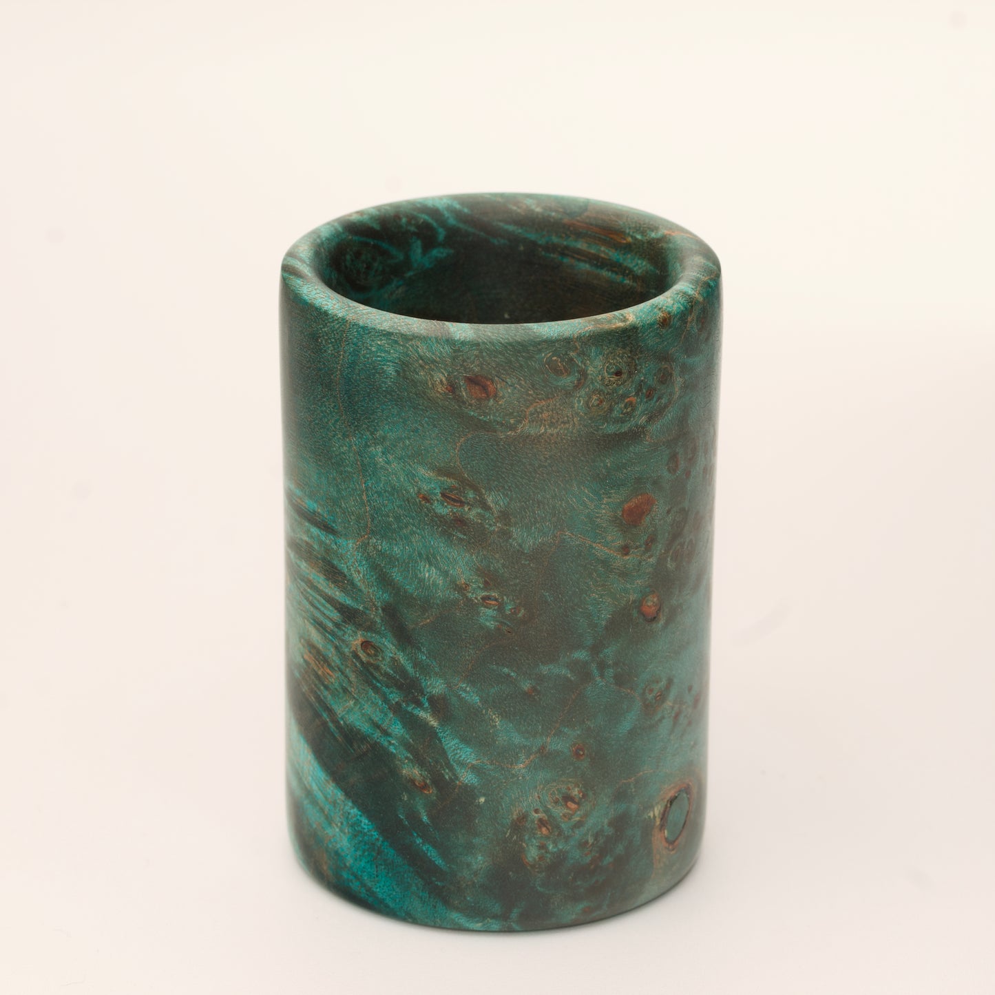 Green Dyed Mappa Burl shot glass against white background