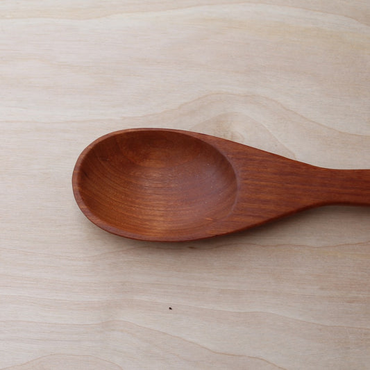 head of a hand made cherry cooking spoon