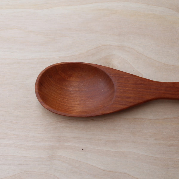 head of a hand made cherry cooking spoon