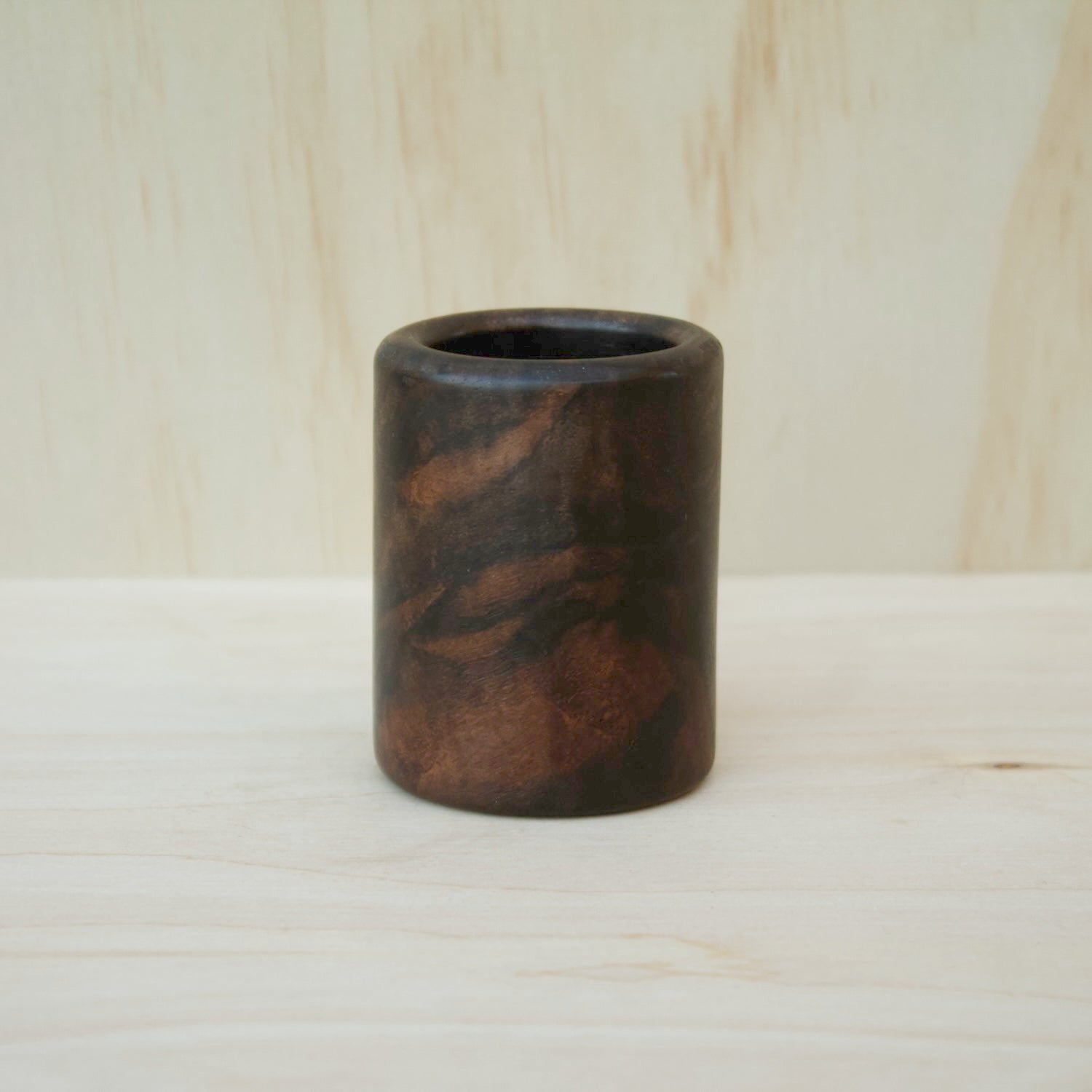 dark wooden cup with bold, intricate grain lines and deep tones