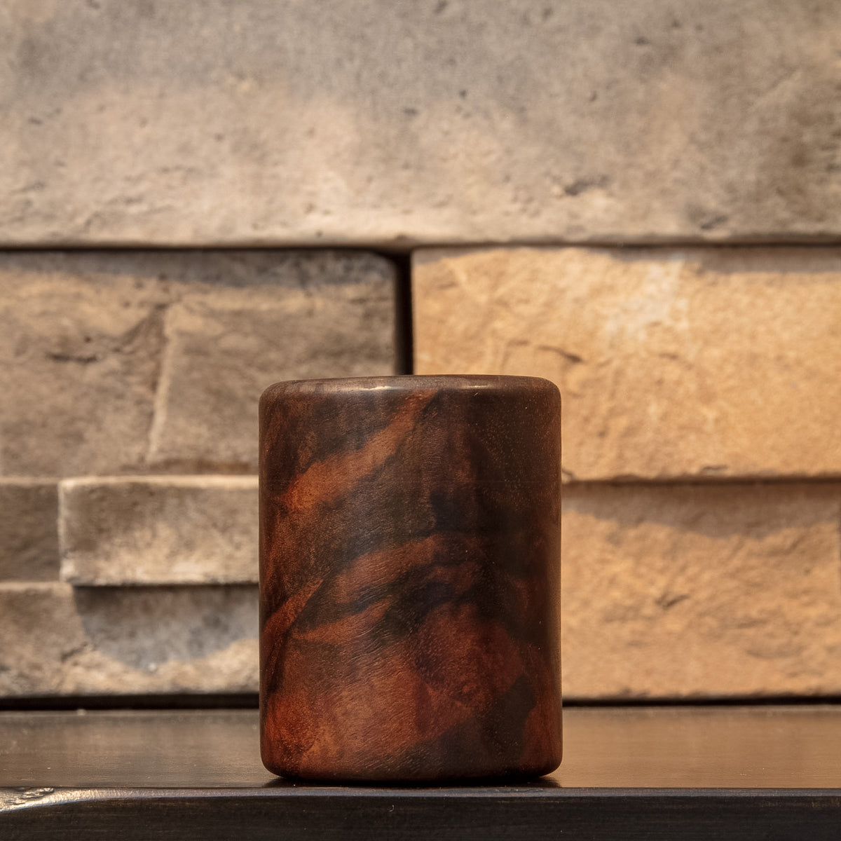 Claro Unbound Claro Walnut shot glass showing sweeping reddish-brown figure across the front face